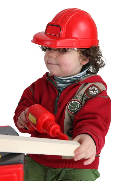 Kleine jongen met speelgoed boor voorwenden om workman — Stockfoto