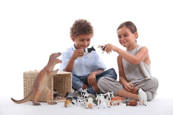 Child playing with toy animals — Stock Photo, Image