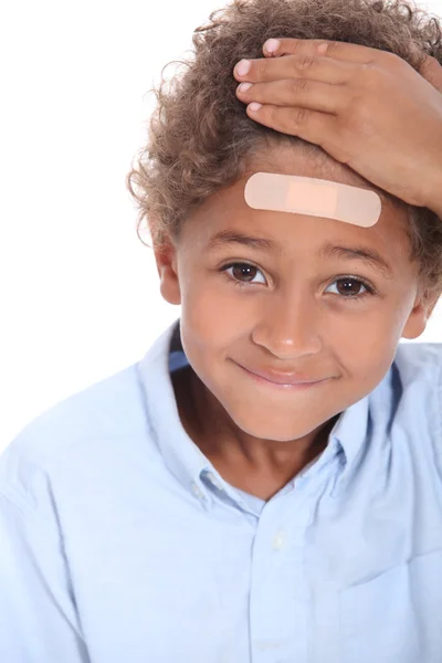 Little boy with plaster on head — Stock Photo, Image