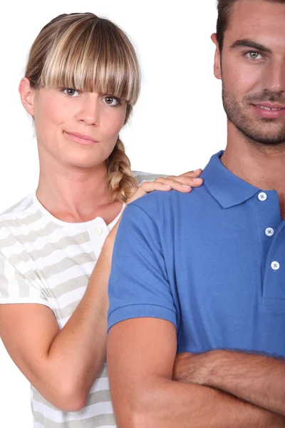 An unsure woman touching her husband's shoulder — Stock Photo, Image