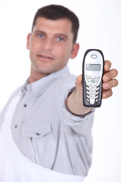 Man holding out mobile telephone — Stock Photo, Image