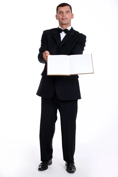 Waitor holding book — Stock Photo, Image