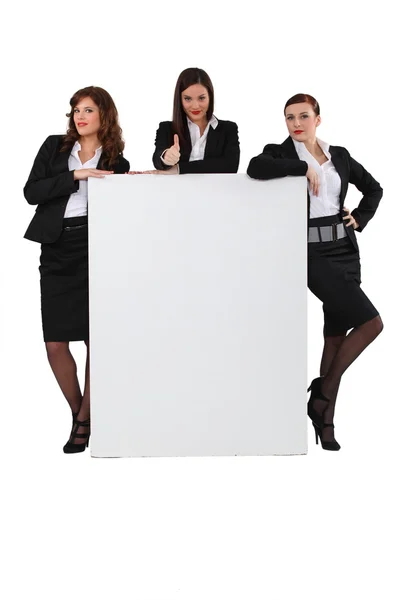 Business women stood with blank message board — Stockfoto