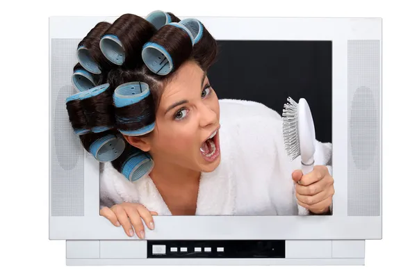 Woman in rollers inside a television — Stock Photo, Image