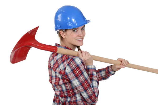Woman carrying spade — Stock Photo, Image