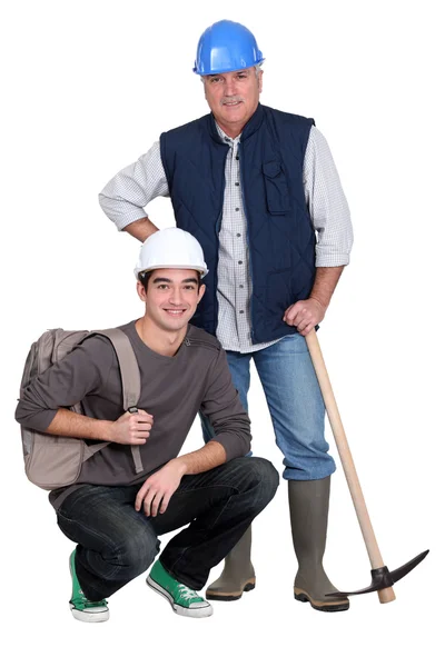 Experienced tradesman posing with his new apprentice — Stock Photo, Image