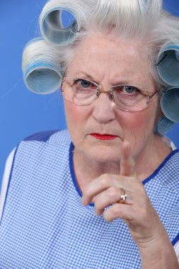 Angry woman with her hair in rollers clipart
