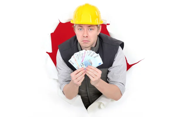 Laborer showing wad of bills — Stock Photo, Image