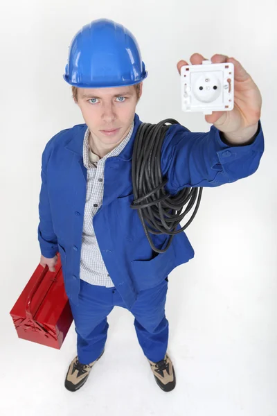High angle shot of young electrician showing socket — Stock Photo, Image