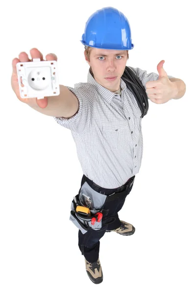 An electrician presenting an outlet. — Stock Photo, Image