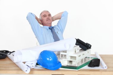 Architect sat at desk clipart