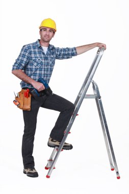 Man with drill climbing ladder clipart