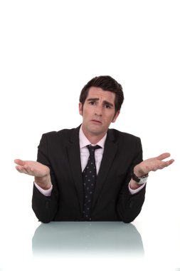 Man in suit with expression of misunderstanding clipart