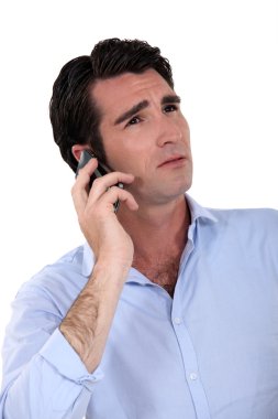 An unhappy man over the phone. clipart