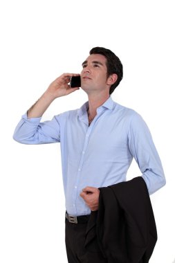 Casual businessman with a cellphone clipart