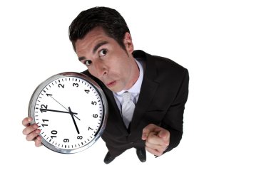 High-angle shot of a businessman holding a clock clipart