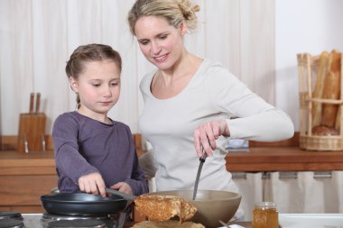 Mother and daughter in the kitchen clipart