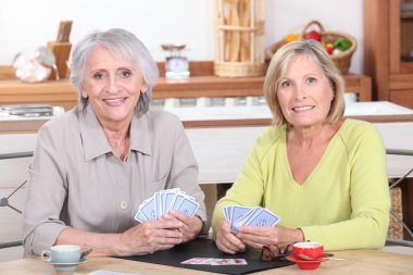 Older women playing cards clipart