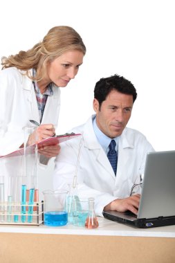 Lab assistants on computer clipart