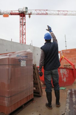 Foreman waving signal to crane operator clipart