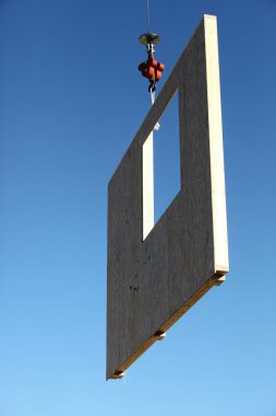Crane lifting concrete wall clipart