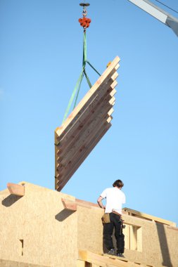 Construction of a wooden building clipart