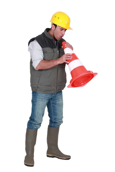 Tradesman blowing into a pylon — Stock Photo, Image