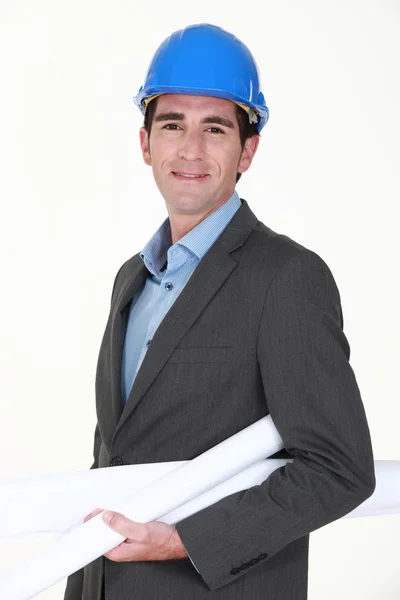 Engineer carrying rolled-up blueprints — Stock Photo, Image