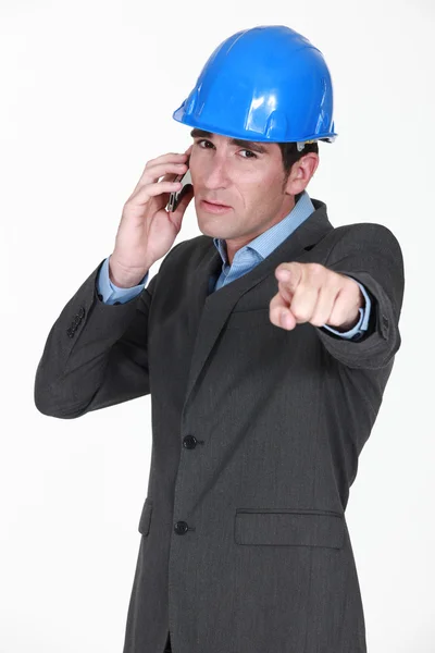 Foreman on the phone pointing at something — Stock Photo, Image