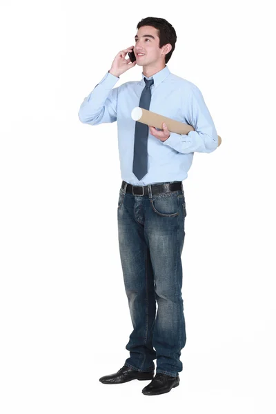 Young man with a document tube and cellphone — Stock Photo, Image