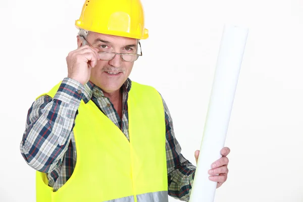 A mature foreman holding plans. — Stock Photo, Image