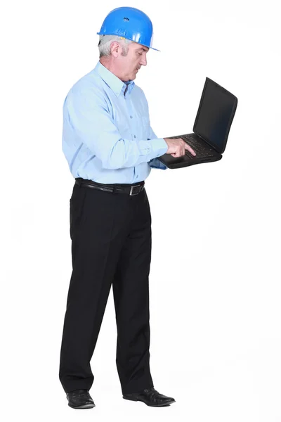 Senior architect typing on laptop — Stock Photo, Image