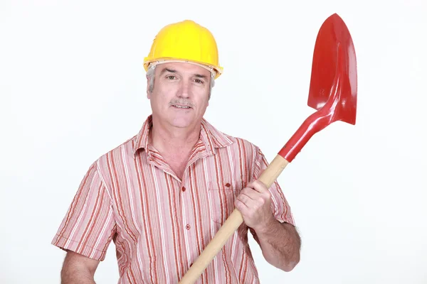 Maturo muratore tenendo pala contro studio sfondo — Foto Stock