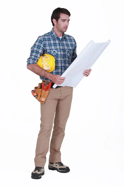 Construction foreman looking at a blueprint — Stock Photo, Image