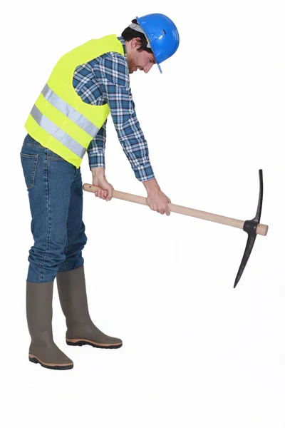 Handyman with a pickaxe. — Stock Photo, Image