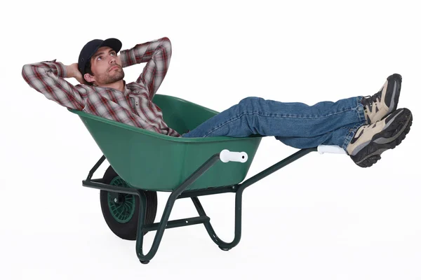 Laborer lying in a wheelbarrow — Stock Photo, Image