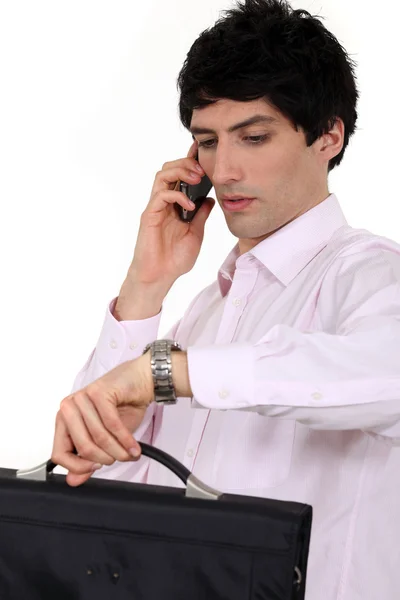 Hurried businessman looking at the time — Stock Photo, Image