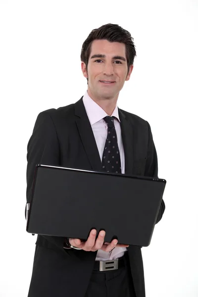 Podnikatel drží jeho laptop — Stock fotografie