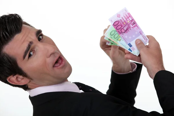 Счастливый бизнесмен держит банкноты — стоковое фото
