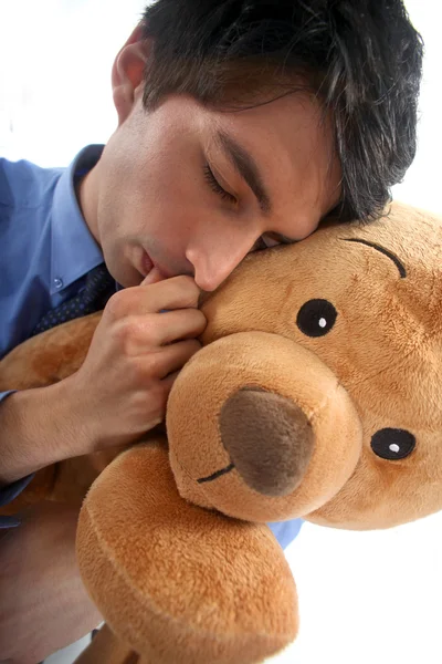 Man hugging a teddy bear — Stockfoto