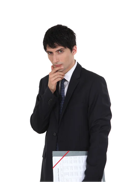 Pensive businessman holding file — Stock Photo, Image