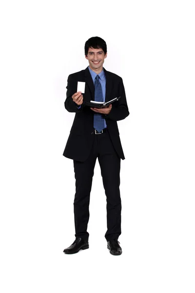 Businessman offering his card from a personal organizer — Stock Photo, Image