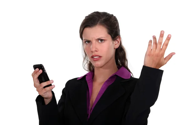 Angry businesswoman holding a cell — Stock Photo, Image
