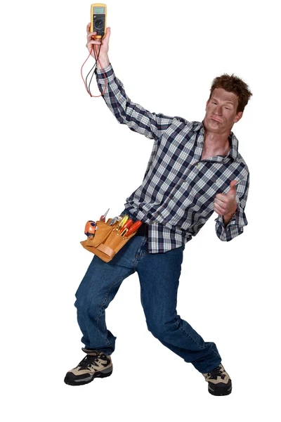 Electrician checking the voltage and getting a shock — Stock Photo, Image
