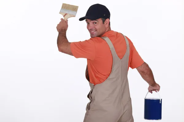Craftsman painter holding a brush and a can — Stock Photo, Image