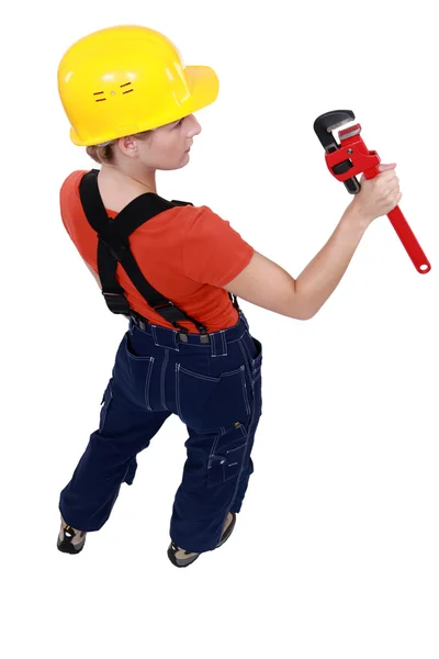 Female plumber holding spanner — Stock Photo, Image