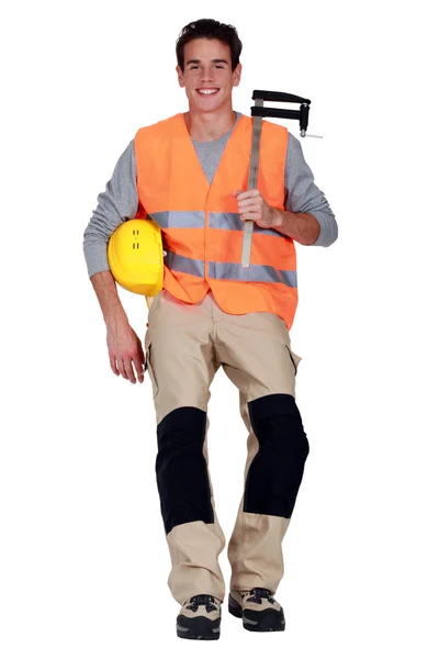 Worker with an F clamp — Stock Photo, Image