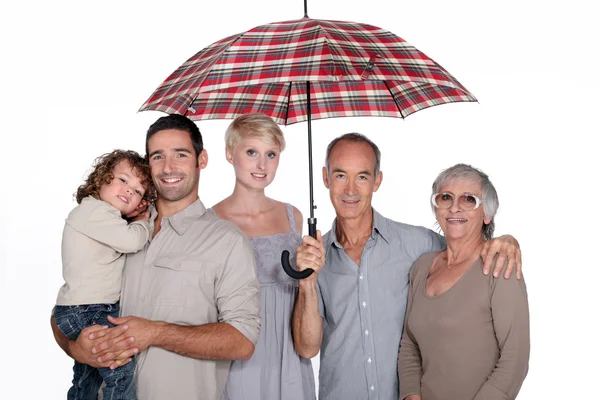 Family under umbrella — Stock Photo, Image