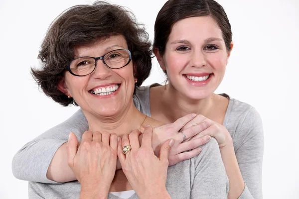 A mother and her teenage daughter hugging. — Stock Photo, Image