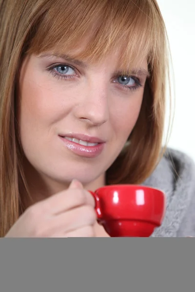 Женщина с красной чашкой кофе — стоковое фото